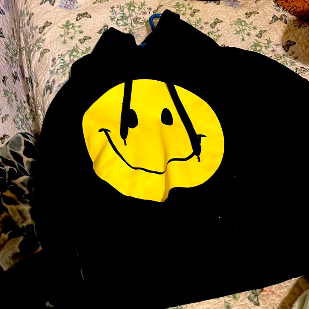 I am selling a smiley face crop top hoodie black with smiley face